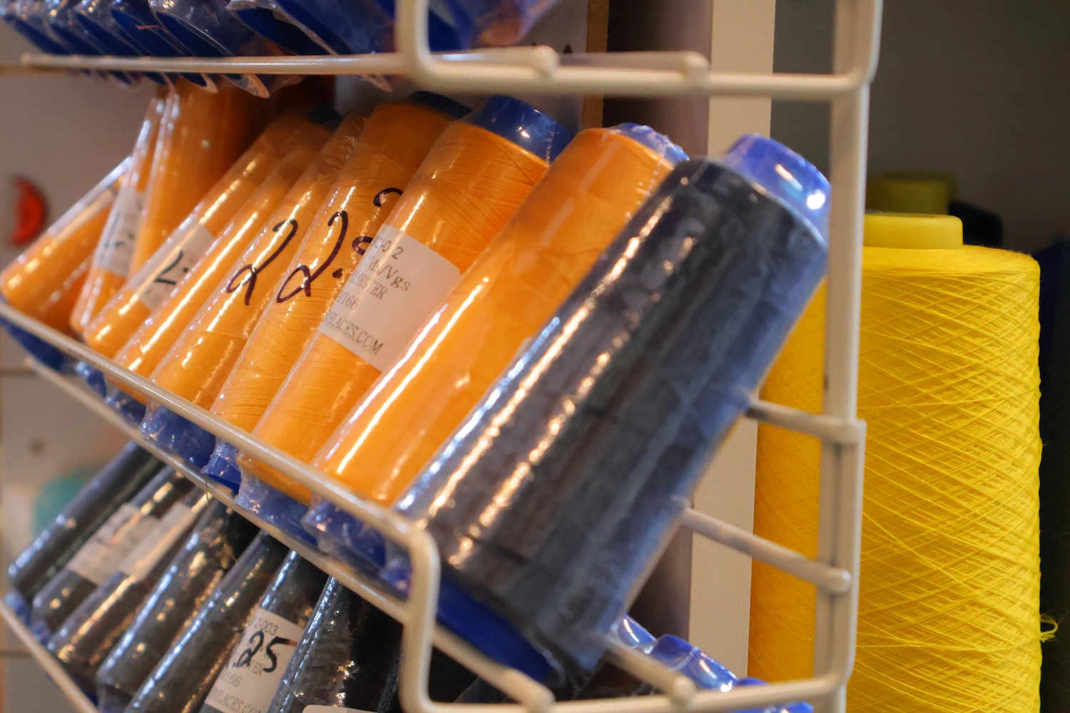 Assorted sewing thread spools in various colors for different fabric projects